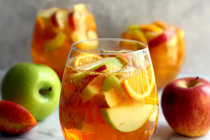 Fresh ingredients for Apple Cider Sangria on a table