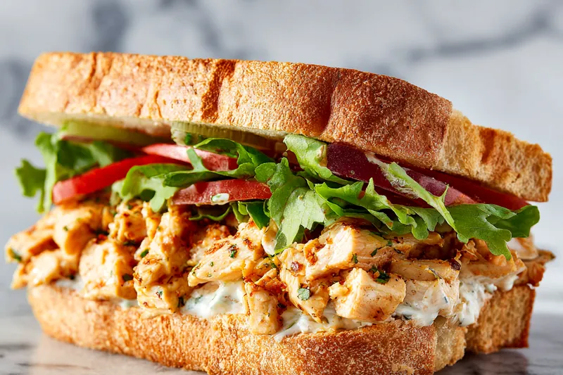 Grilling chicken on a pan for the sandwich