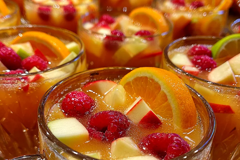 A step-by-step process of preparing Festive Thanksgiving Punch with all ingredients laid out.